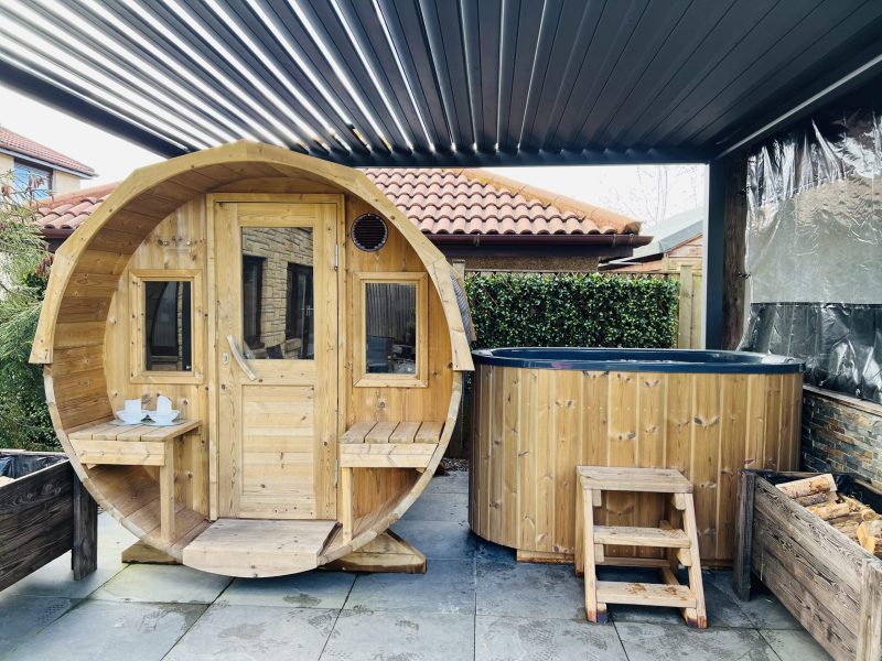 cold plunge bath beside barrel sauna