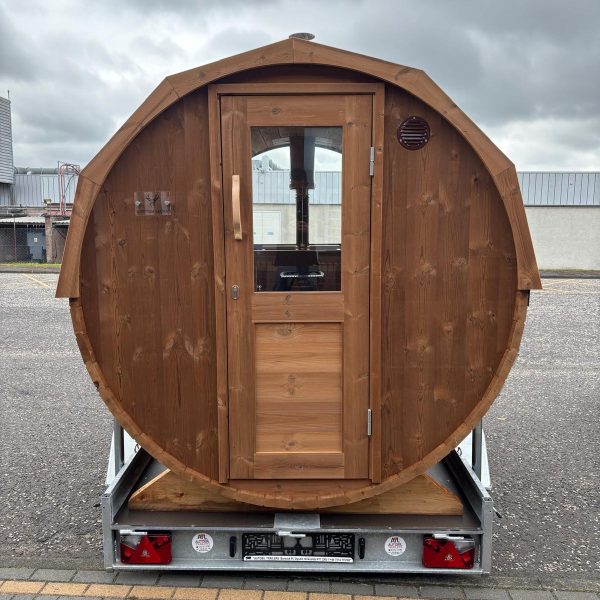 barrel sauna on a trailer showing front door