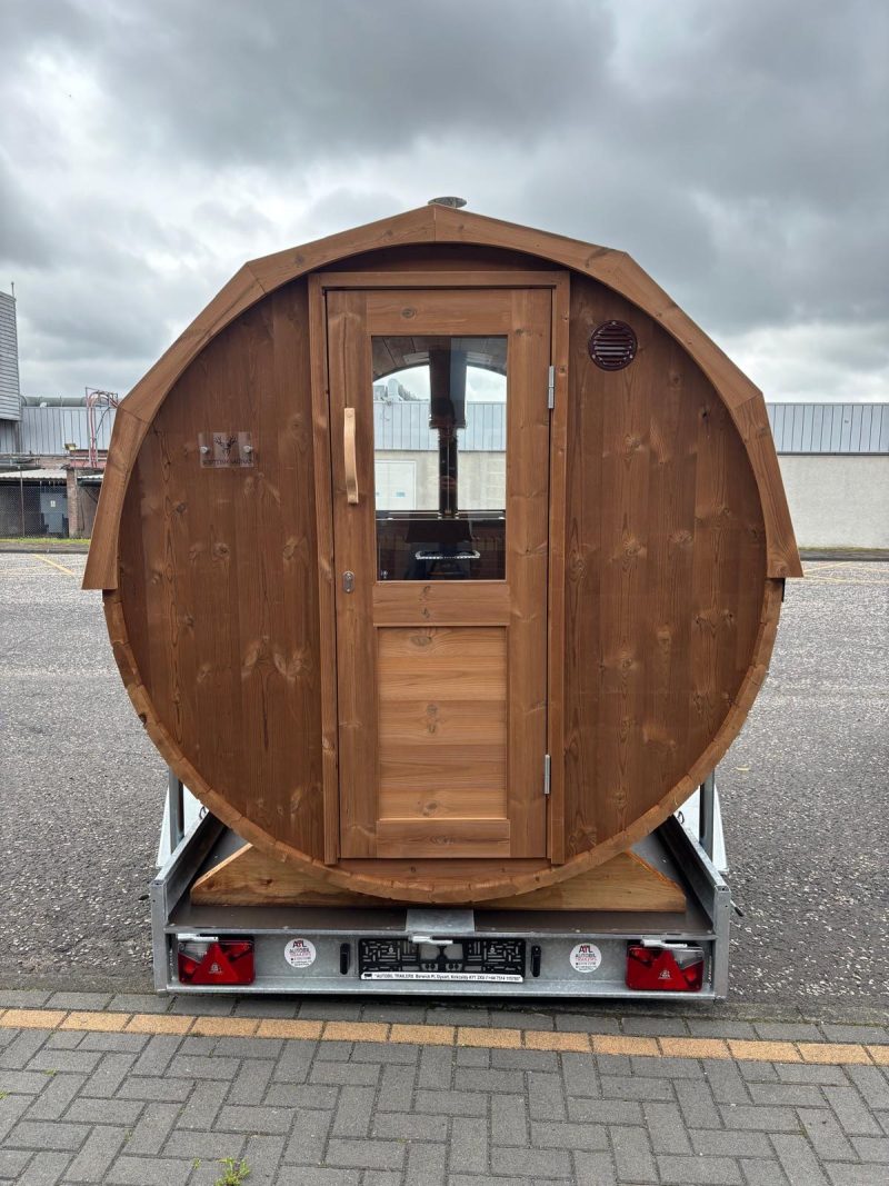 barrel sauna on a trailer showing front door