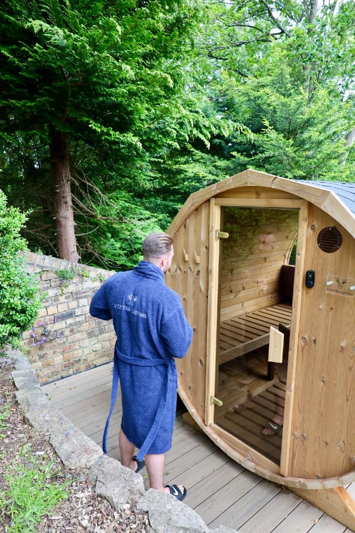 man entering barrel sauna